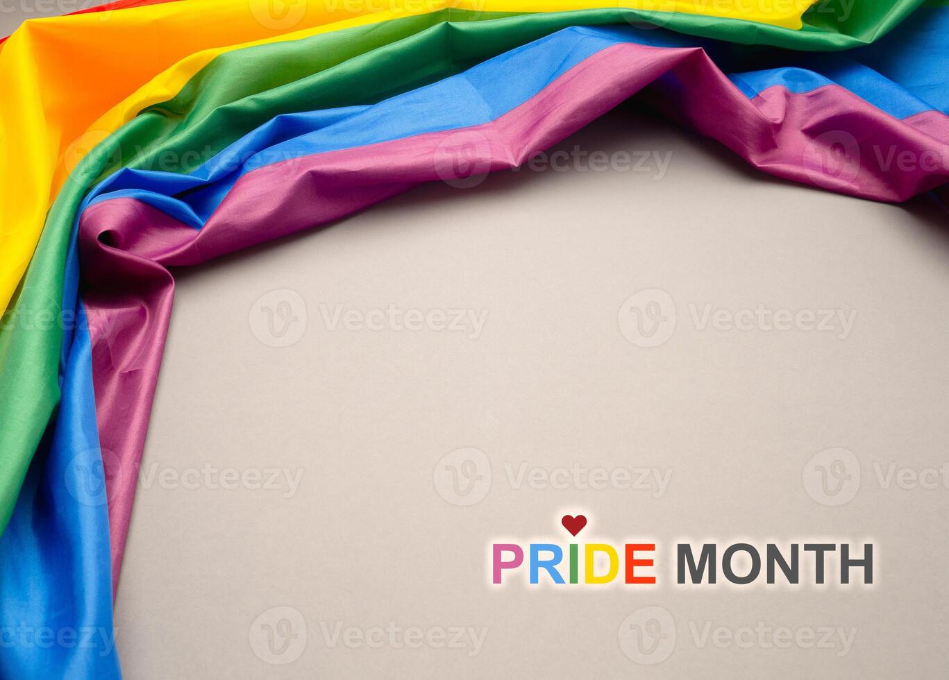 Pride month. Top view of the rainbow flag or LGBT is on a gray background with copy space photo