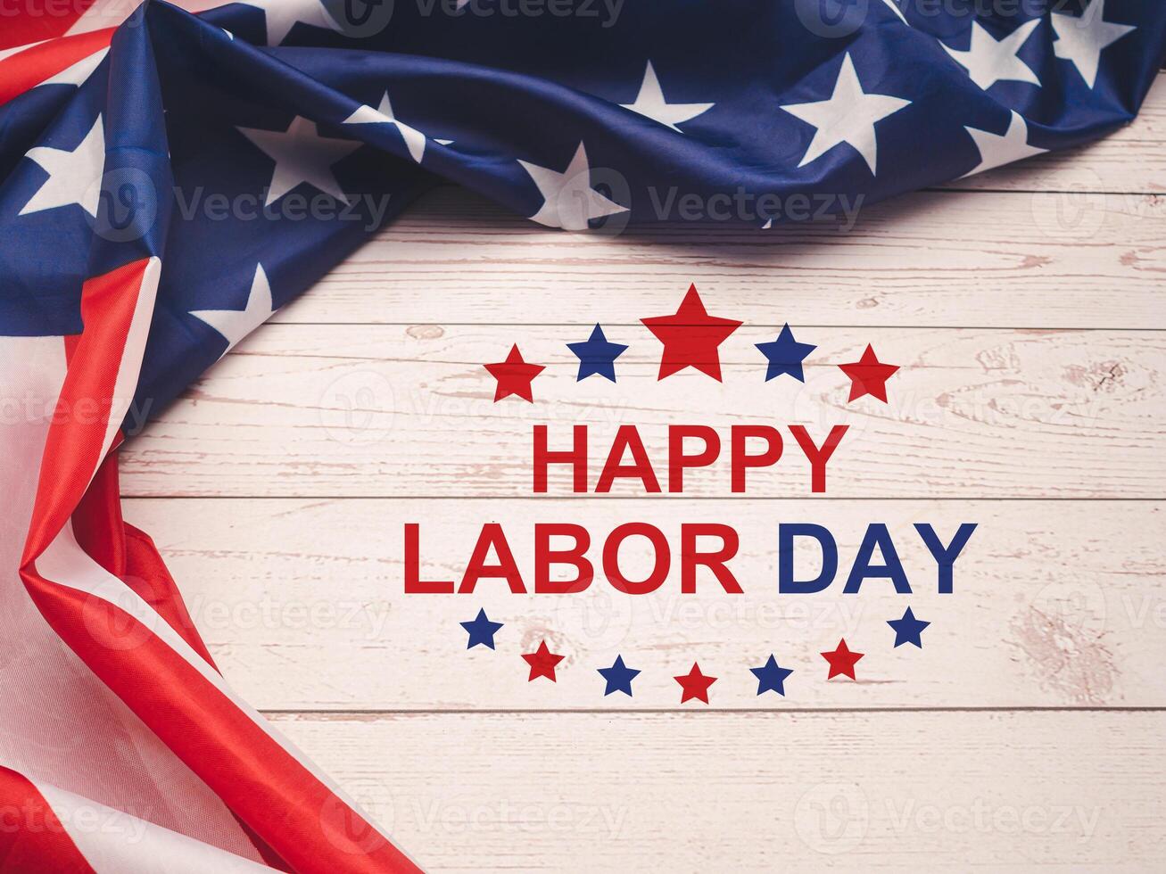 Happy labor day text over a wooden table and American Flag photo