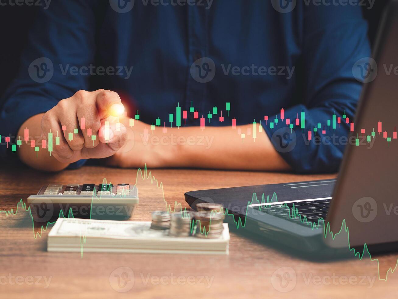 Hand of a businessman pointing to graph stock on a virtual screen while sitting in the office photo