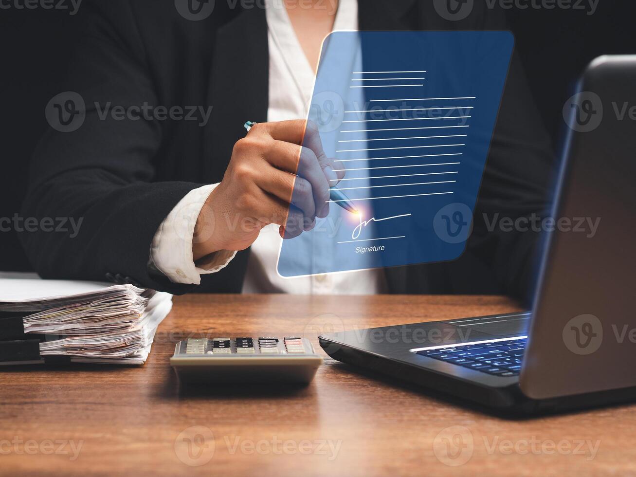 Electronic signature. A businesswoman uses a pen to sign electronic documents on digital documents on a virtual screen photo