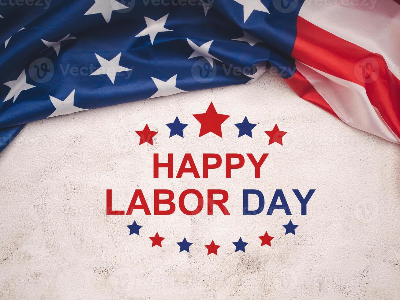 Happy labor day text over a cement floor and American Flag photo