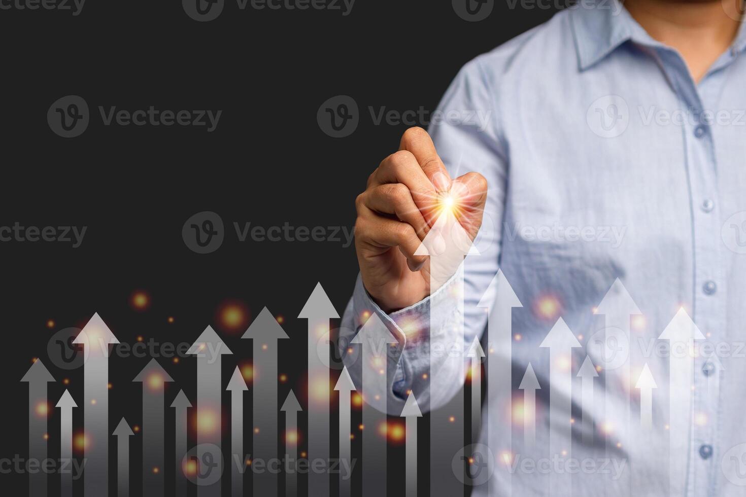 Businessman planning growth future in his business on a virtual screen while standing on a gray background photo