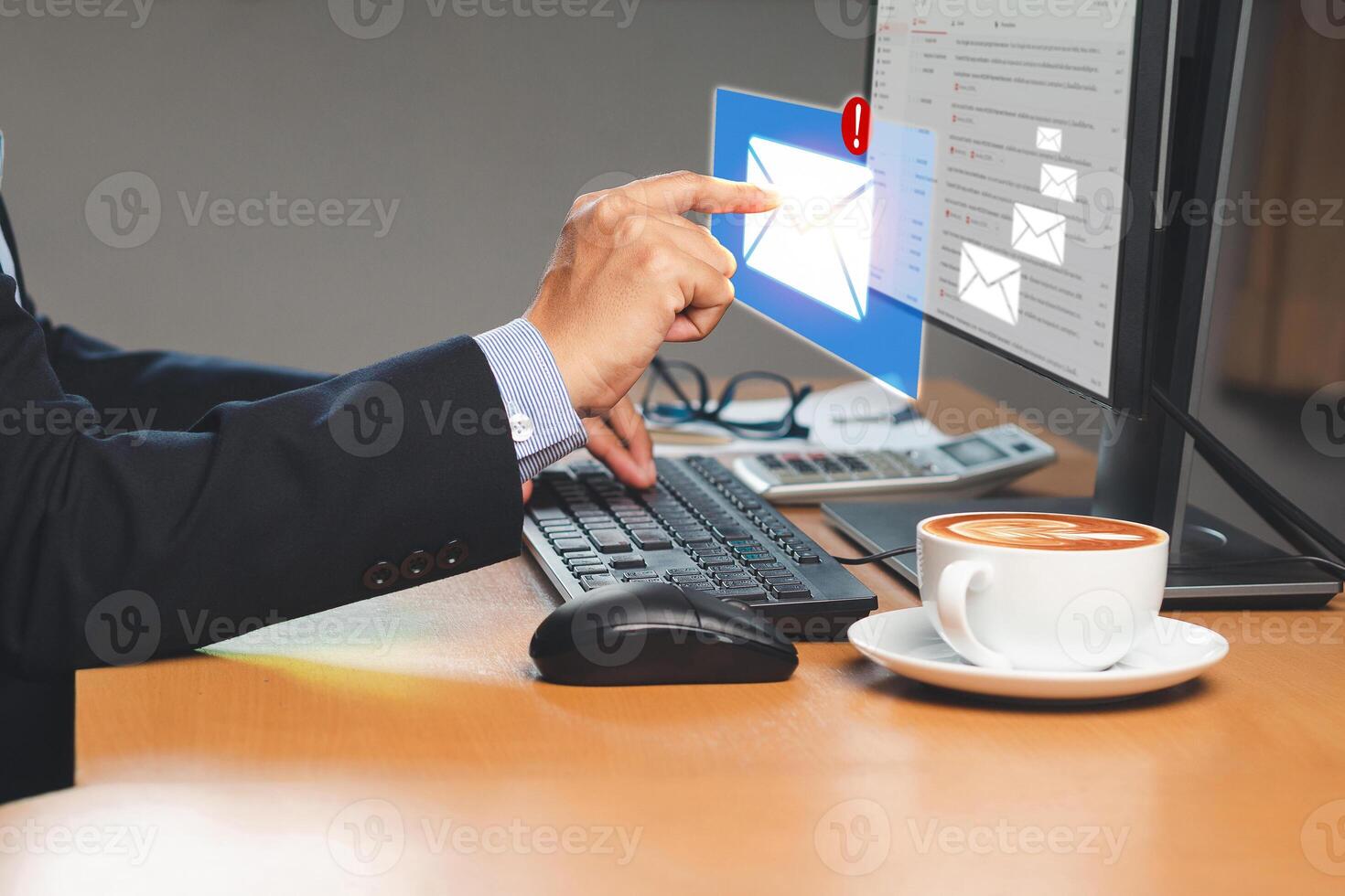 Businessman receives a new message with email icons on a virtual screen while sitting in the office photo