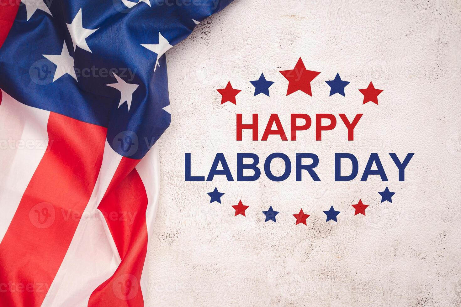 Happy Labor Day text over a cement floor and American Flag photo