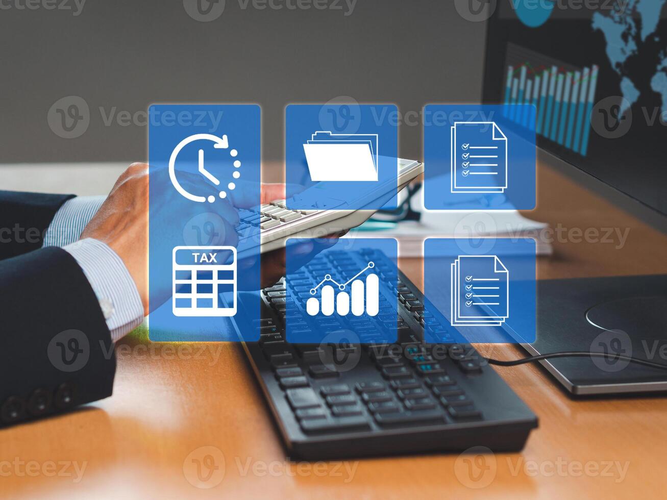 A businessman uses a calculator to calculate taxes while sitting in the office photo