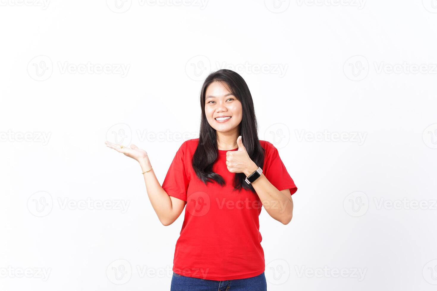 Presenting and Showing Product on Open Palm With Thumbs up Of Beautiful Asian Woman wearing red shirt Isolated On White Background photo