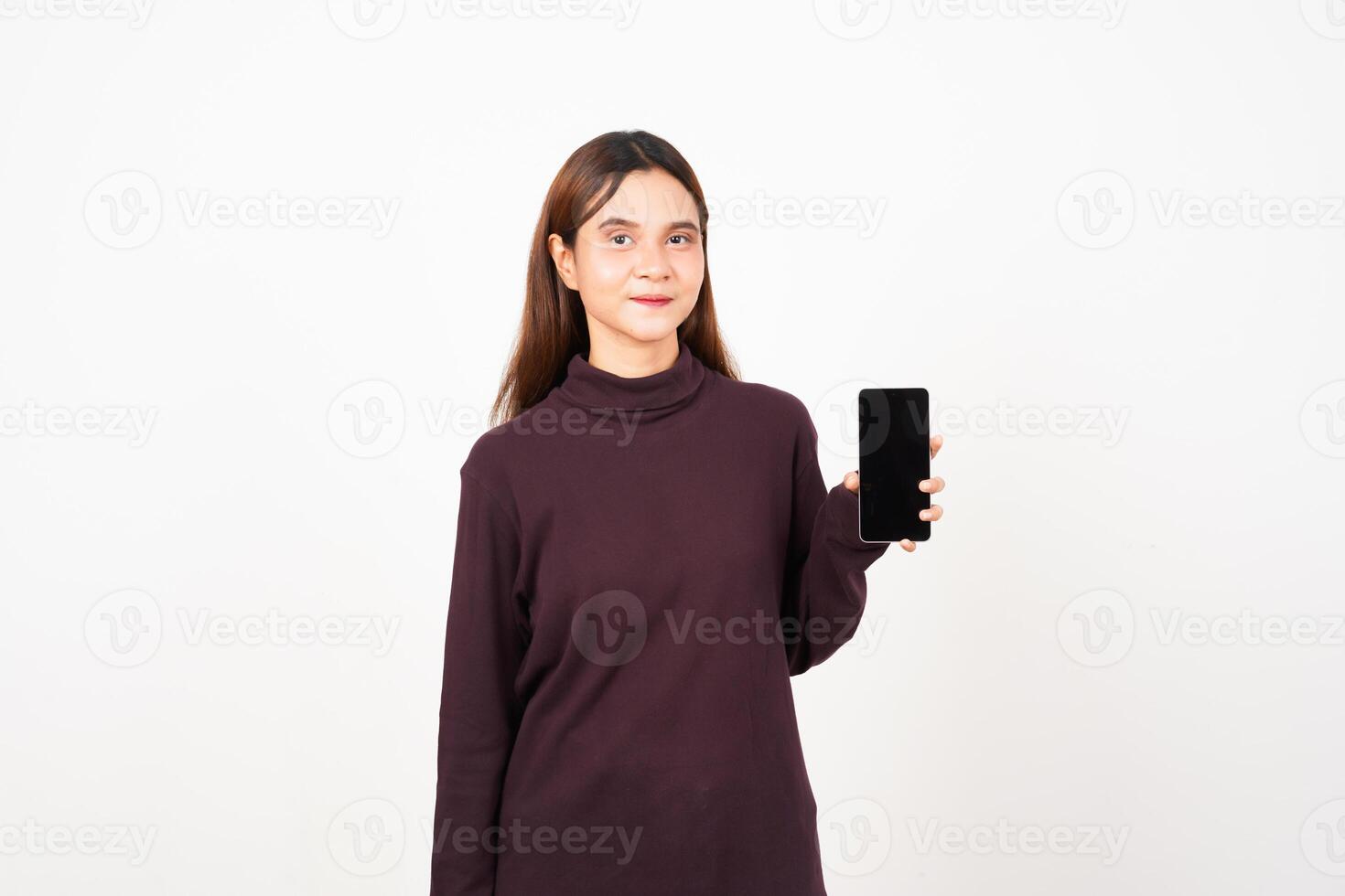Smiling presenting and holding blank screen smartphone Of Beautiful Asian Woman Isolated On White Background photo