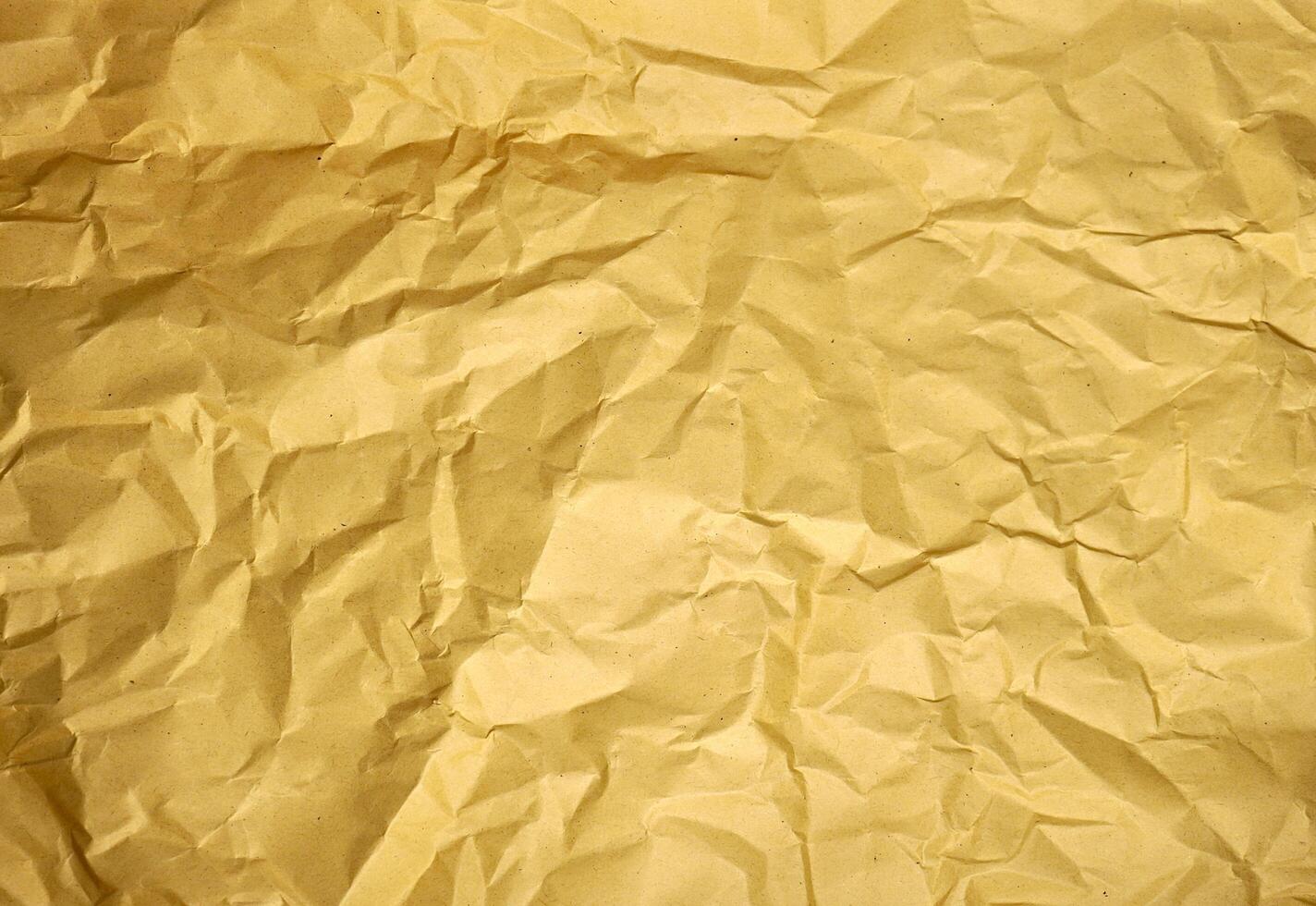 Wrinkled and crumpled textures on brown kraft paper wallpaper isolated on horizontal background. photo