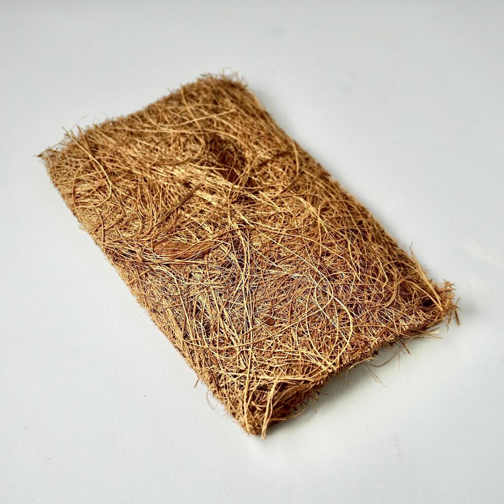 Brown house cleaning scrubber tool from coconut heap material isolated on square white background. photo
