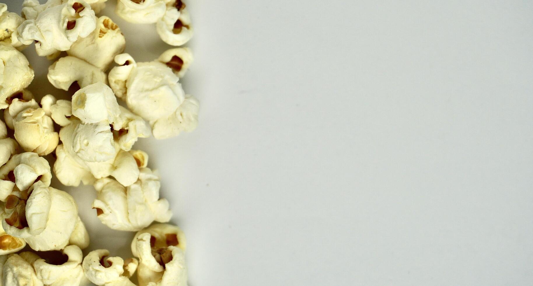 Group of pop corn snacks isolated on horizontal copy spaced plain background. photo