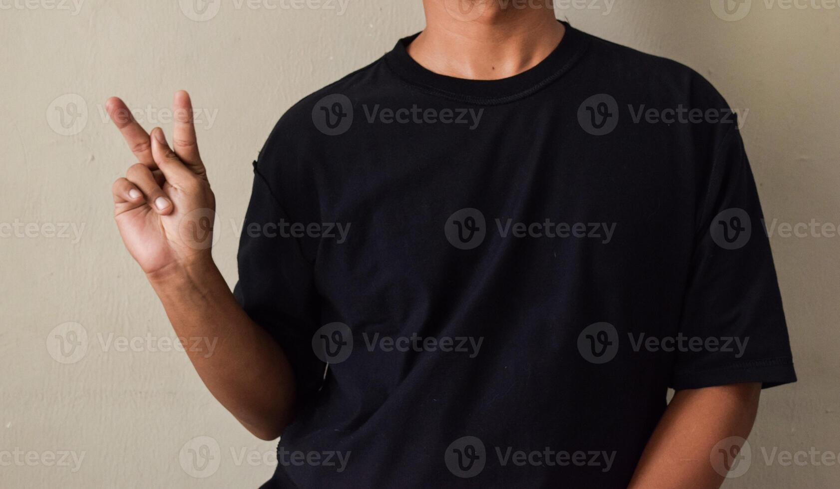 Young man letter K. Finger spelling alphabet in ASL photo