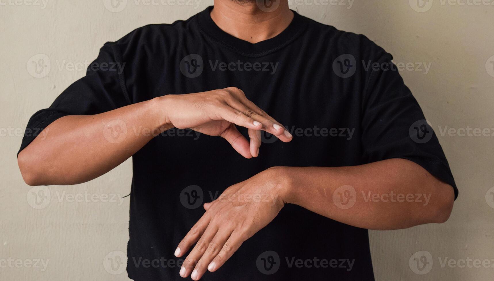 Young man learns sign language to talk, hand gestures of people with hearing impairment photo