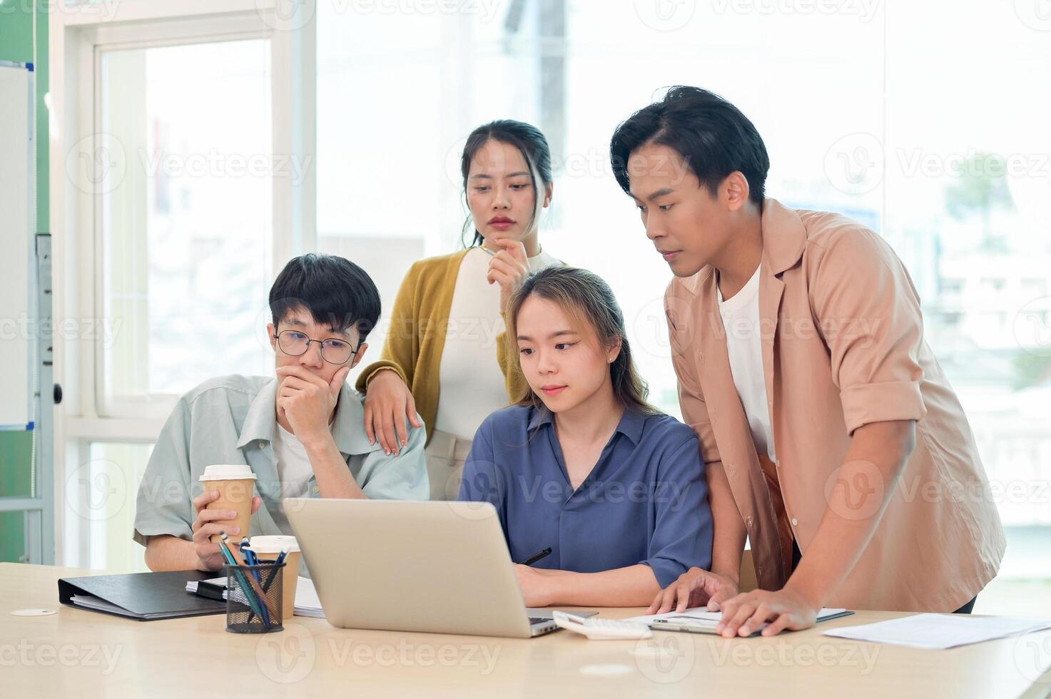 A group of young business startup team focused on discussing and brainstorming in the office. photo