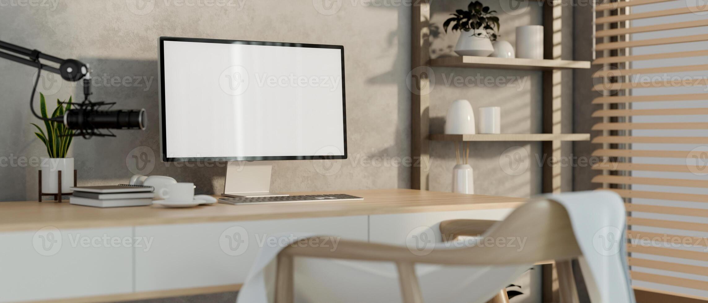 A modern, minimalist radio podcast office featuring a computer, a microphone, and decor. photo
