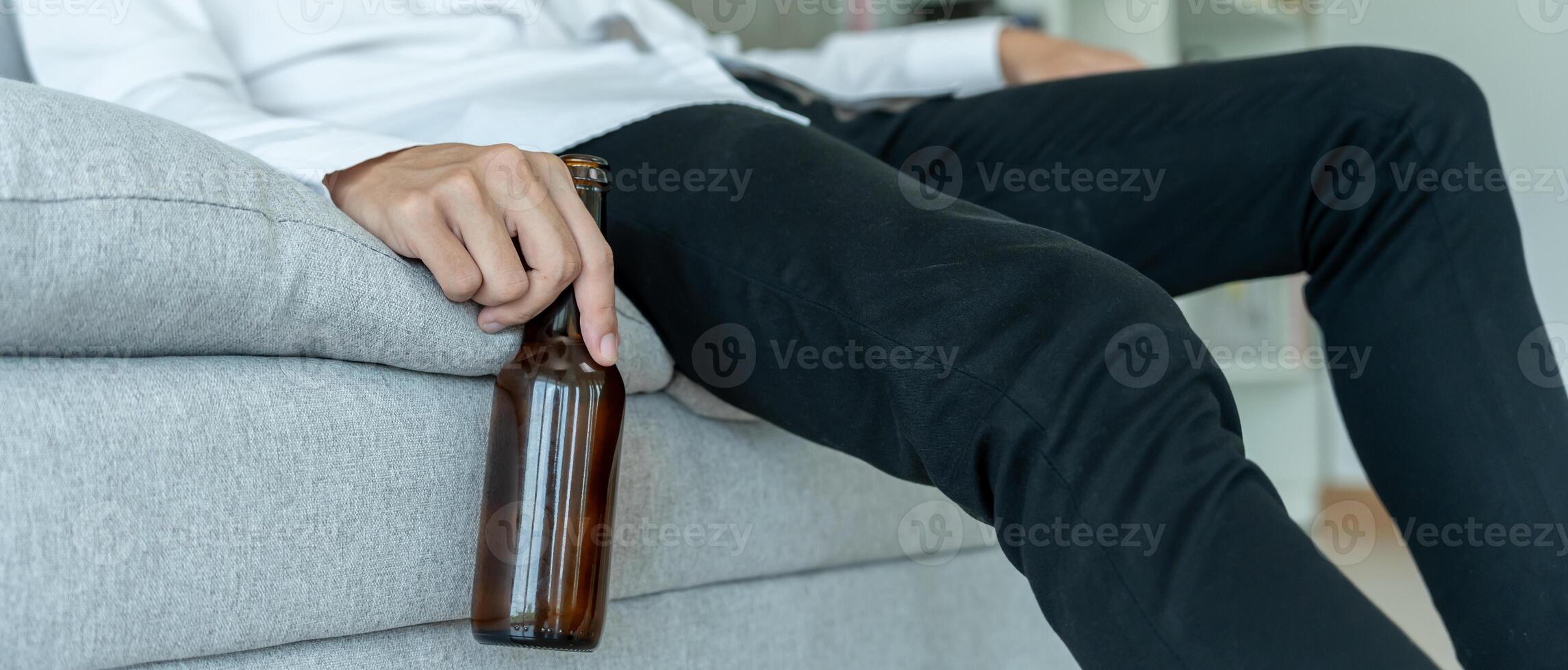Depressed young business man addicted feeling bad drinking whiskey alone at home, stressed frustrated lonely drinking alcohol suffers from problematic liquor, alcoholism, life and family problems photo
