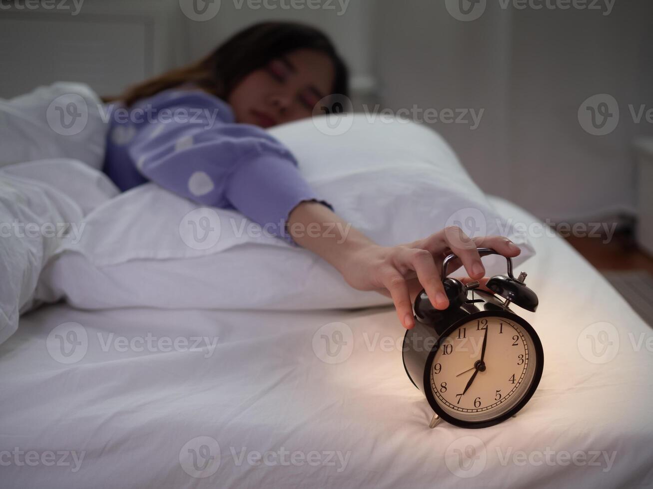 Lazy Asia young woman close a clock alarm, lady is late appointment or work or class study, overslept, difficulty get up in mornings, time worried, not on time, sleepy, over due, Hurry up time photo