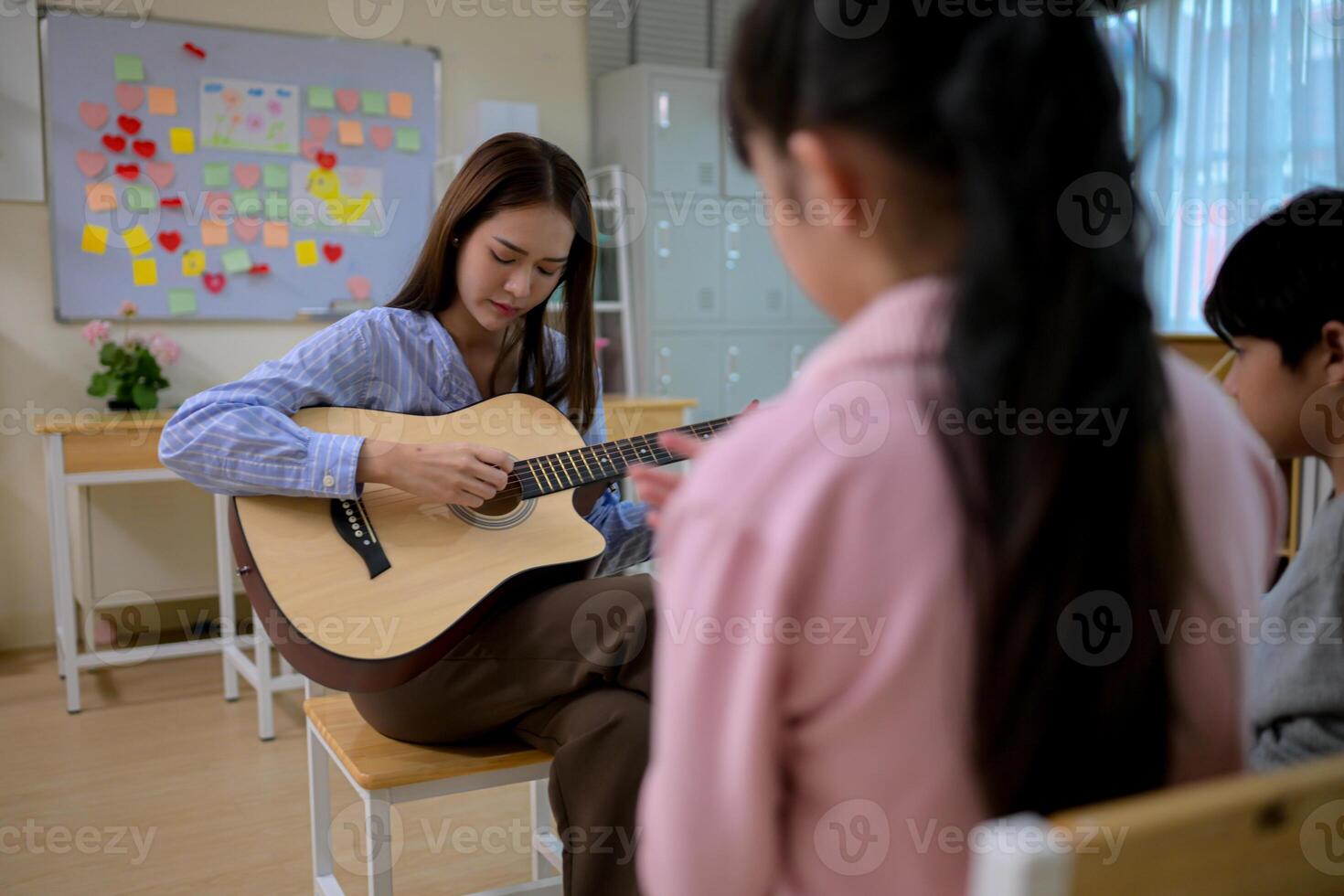 Guitar Class, Teacher and students in music classroom photo