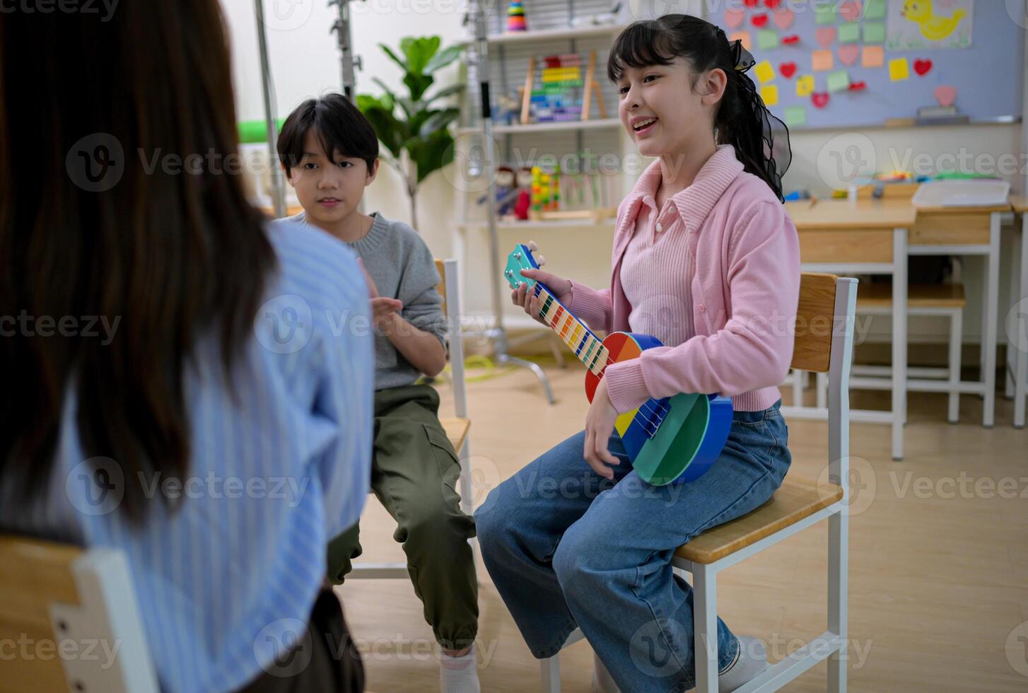 Ukelele Class, Teacher and students in music classroom photo