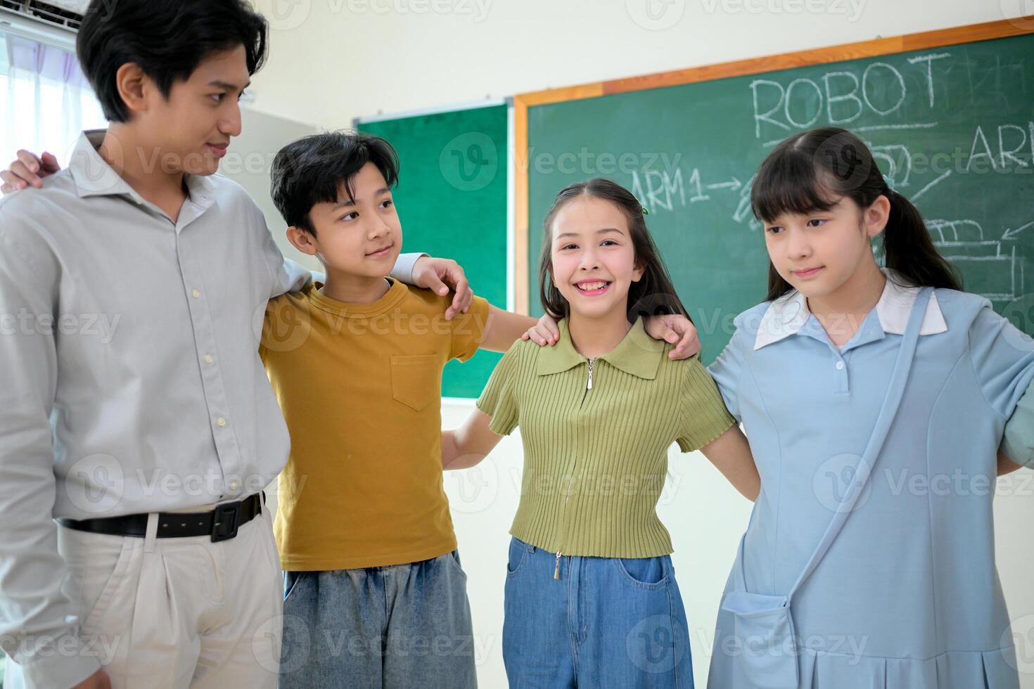 Portrait of a teacher and kids in a classroom where children have pleasure learning photo