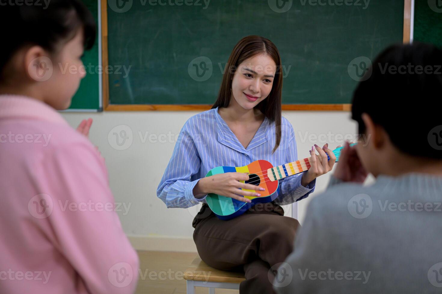 Ukelele Class, Teacher and students in music classroom photo
