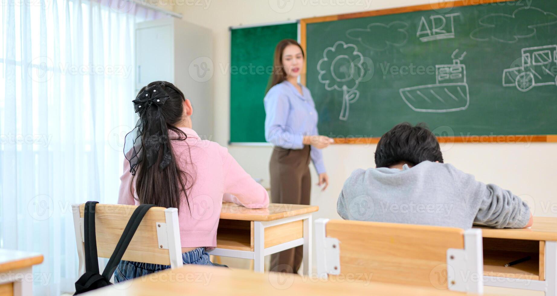 Art lesson, Teacher and students in the basic art classroom photo