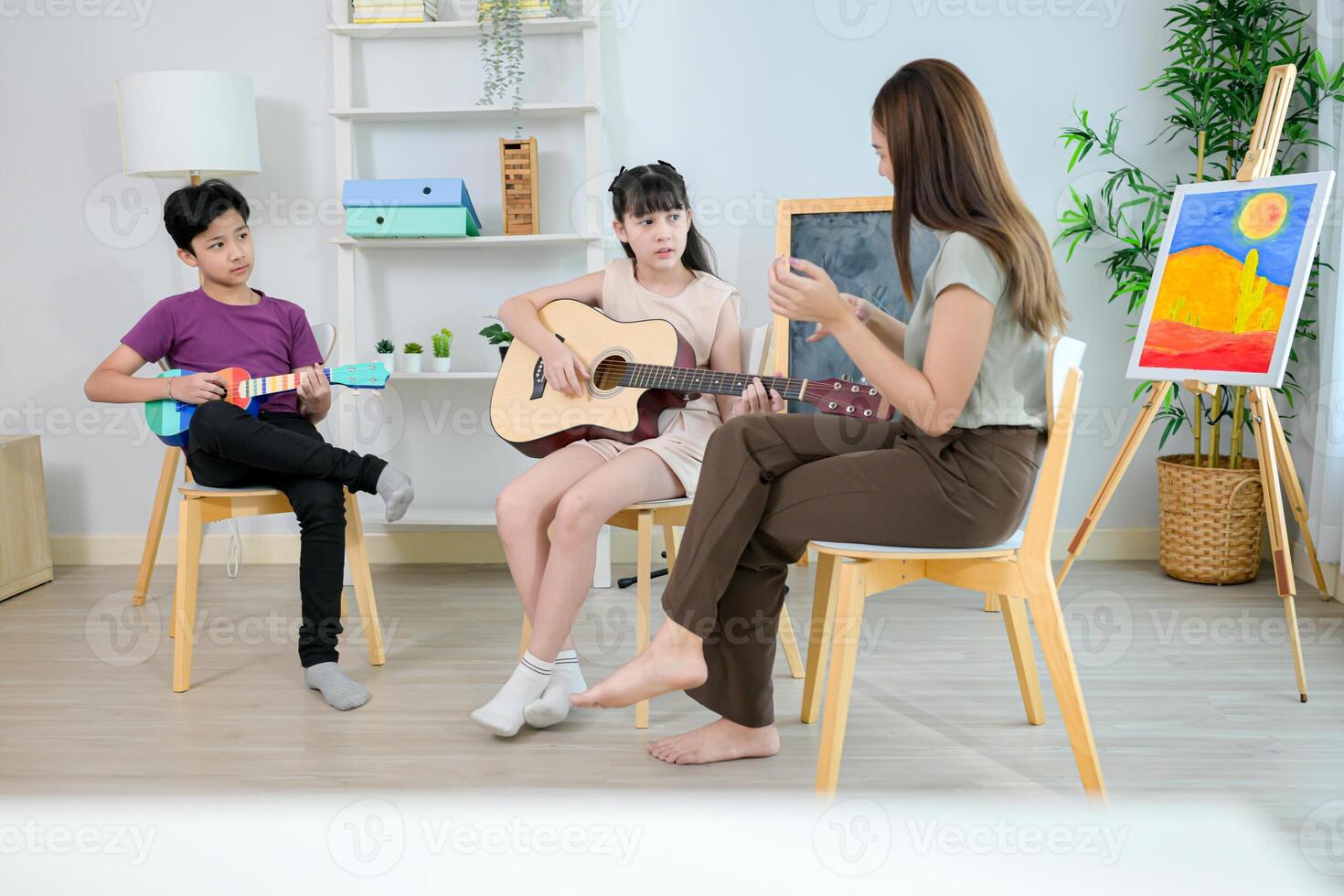 Ukelele and Guitar class, Teacher and students in music classroom photo