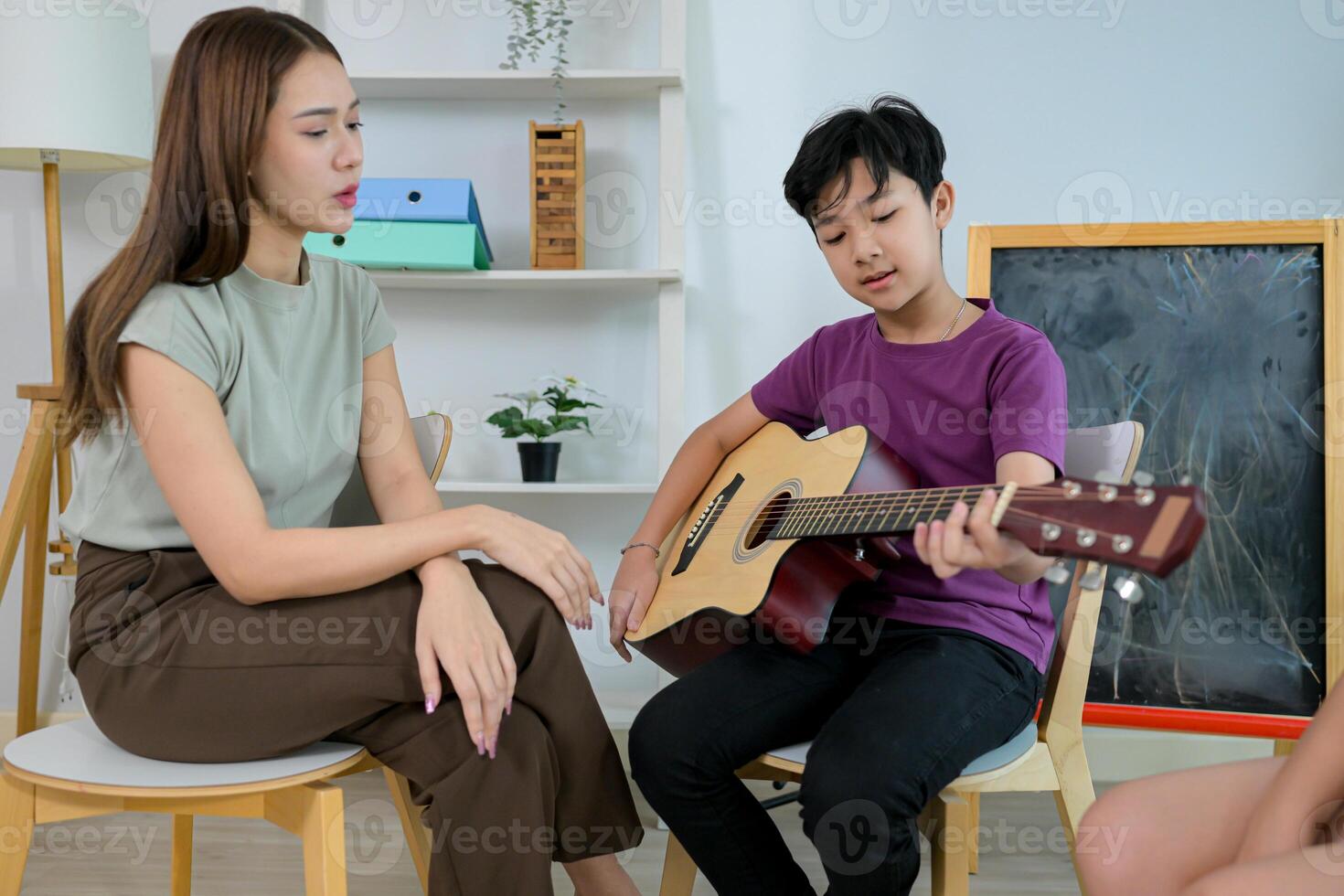 Guitar Class, Teacher and students in music classroom photo