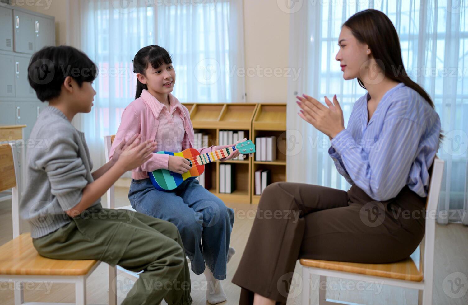 Ukelele Class, Teacher and students in music classroom photo