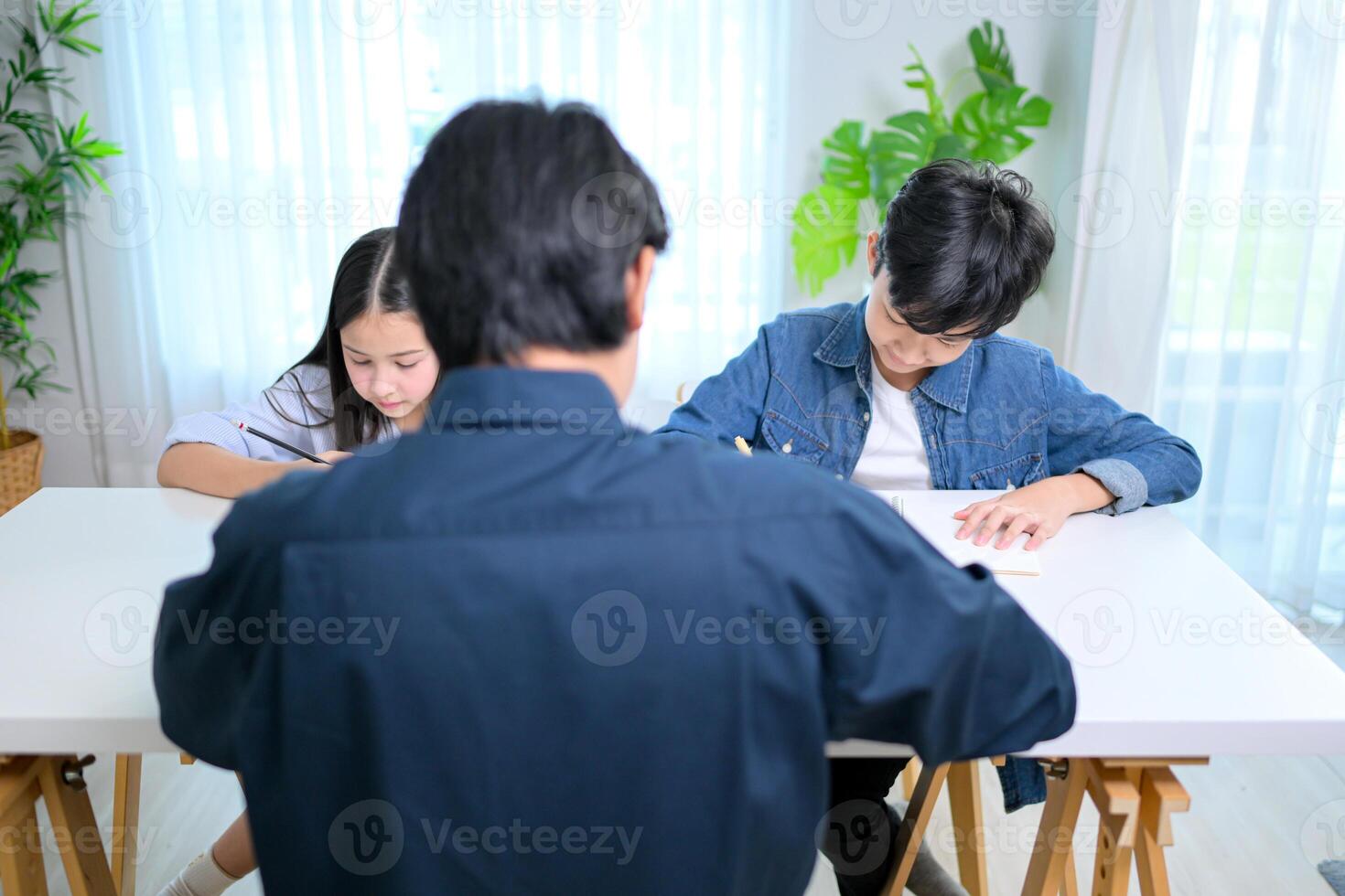 Small class, Teacher and pupils in the home classroom, reviewing lessons and offering homework advice photo