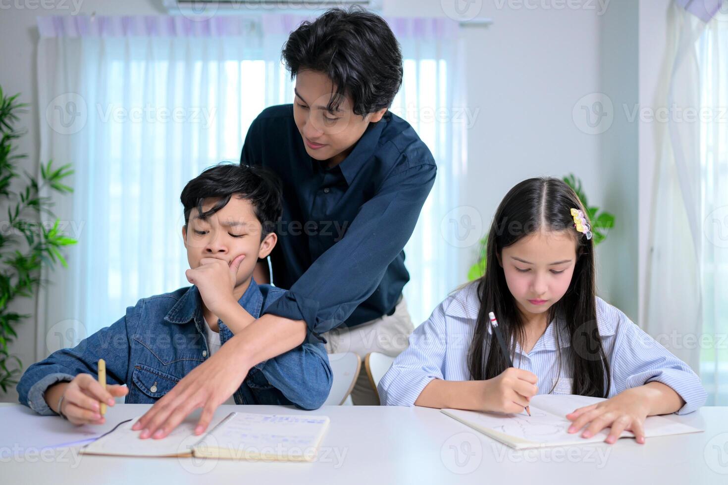 Small class, Teacher and pupils in the home classroom, reviewing lessons and offering homework advice photo
