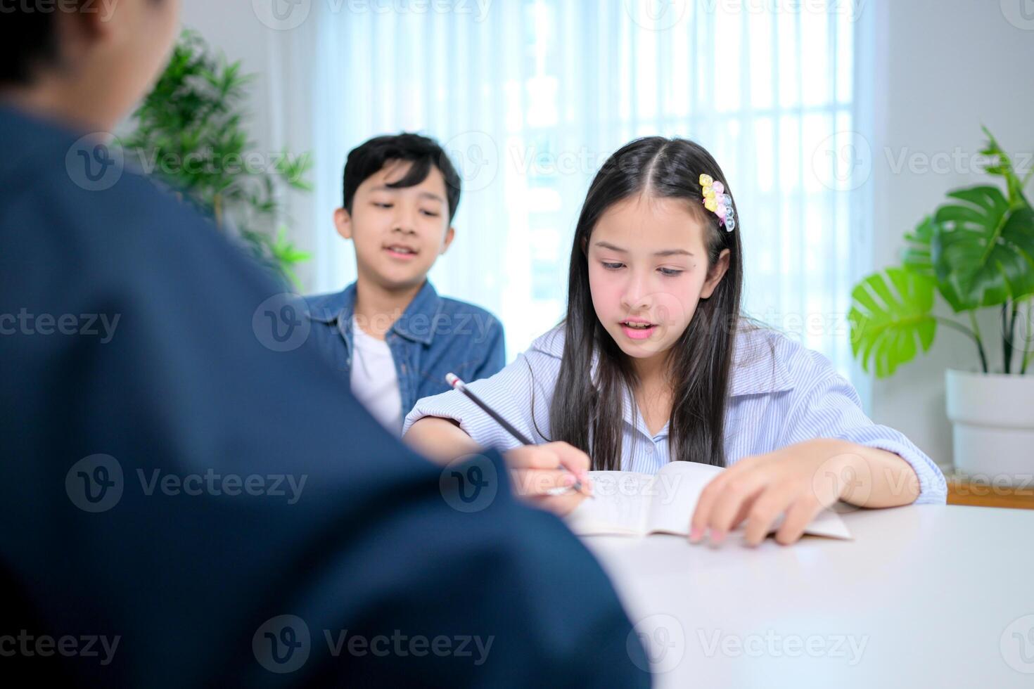 Small class, Teacher and pupils in the home classroom, reviewing lessons and offering homework advice photo