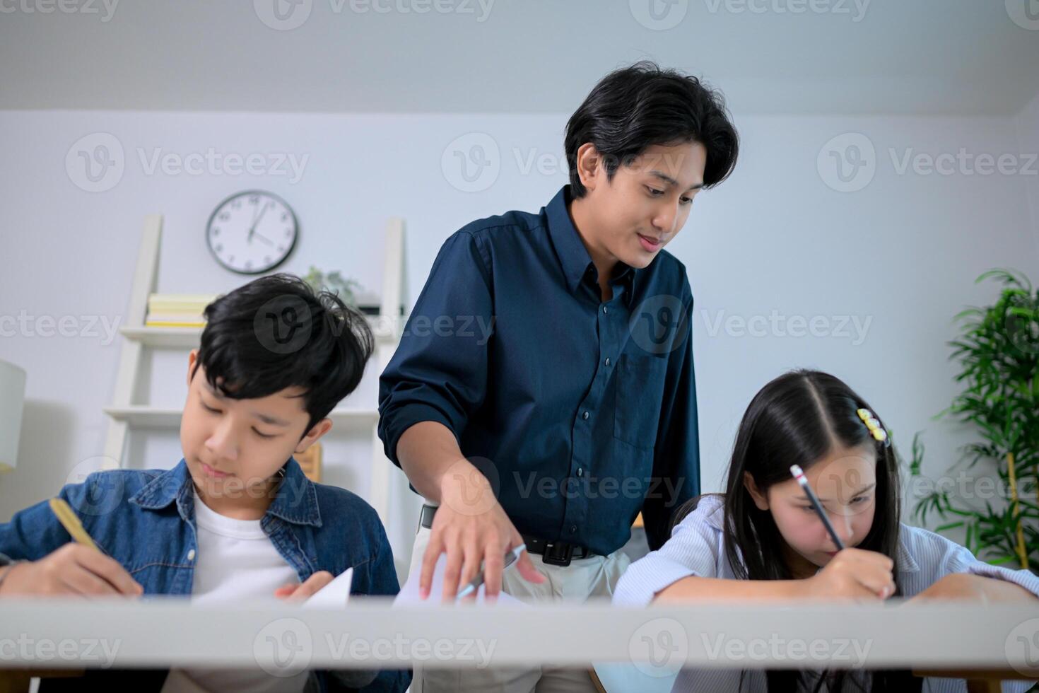Small class, Teacher and pupils in the home classroom, reviewing lessons and offering homework advice photo