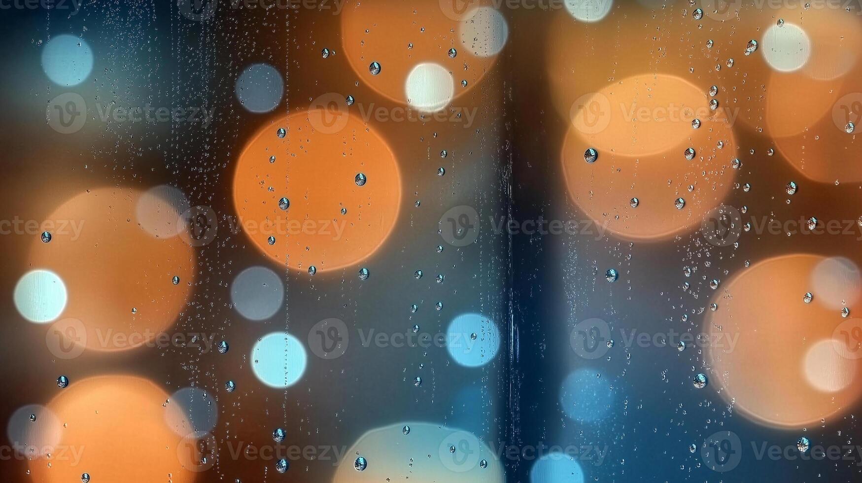Raindrops on the window, blurred by the light photo