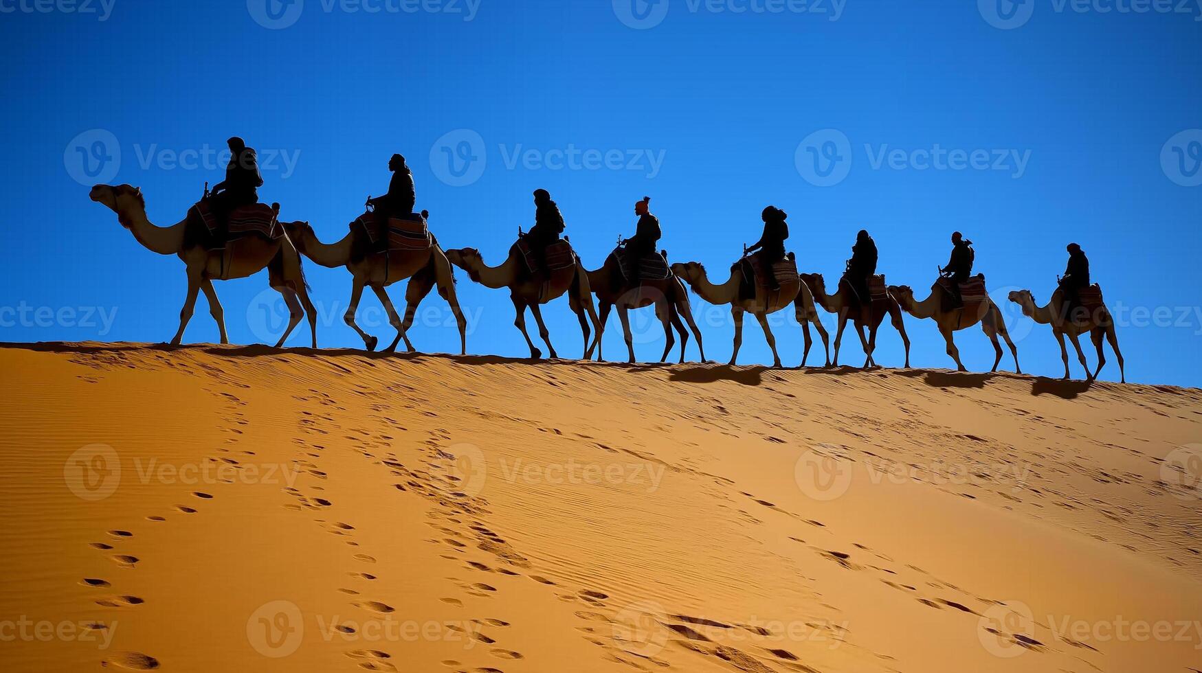 A group of people riding on camels across a desert photo