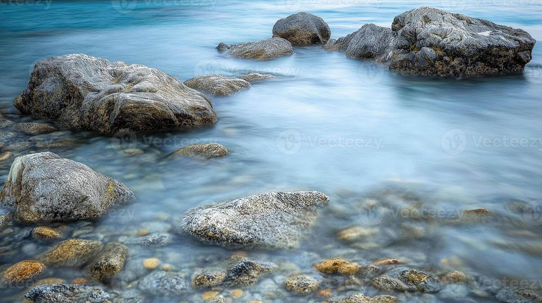 Rocks in the water at the beach photo