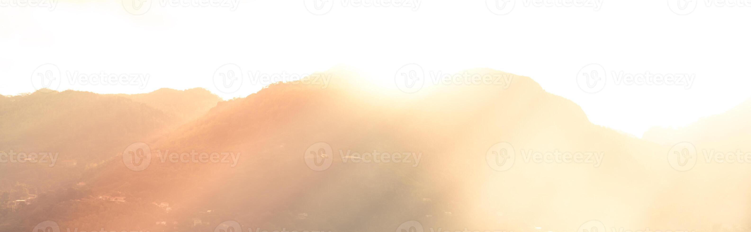 Mountains and bright sun light beams photo
