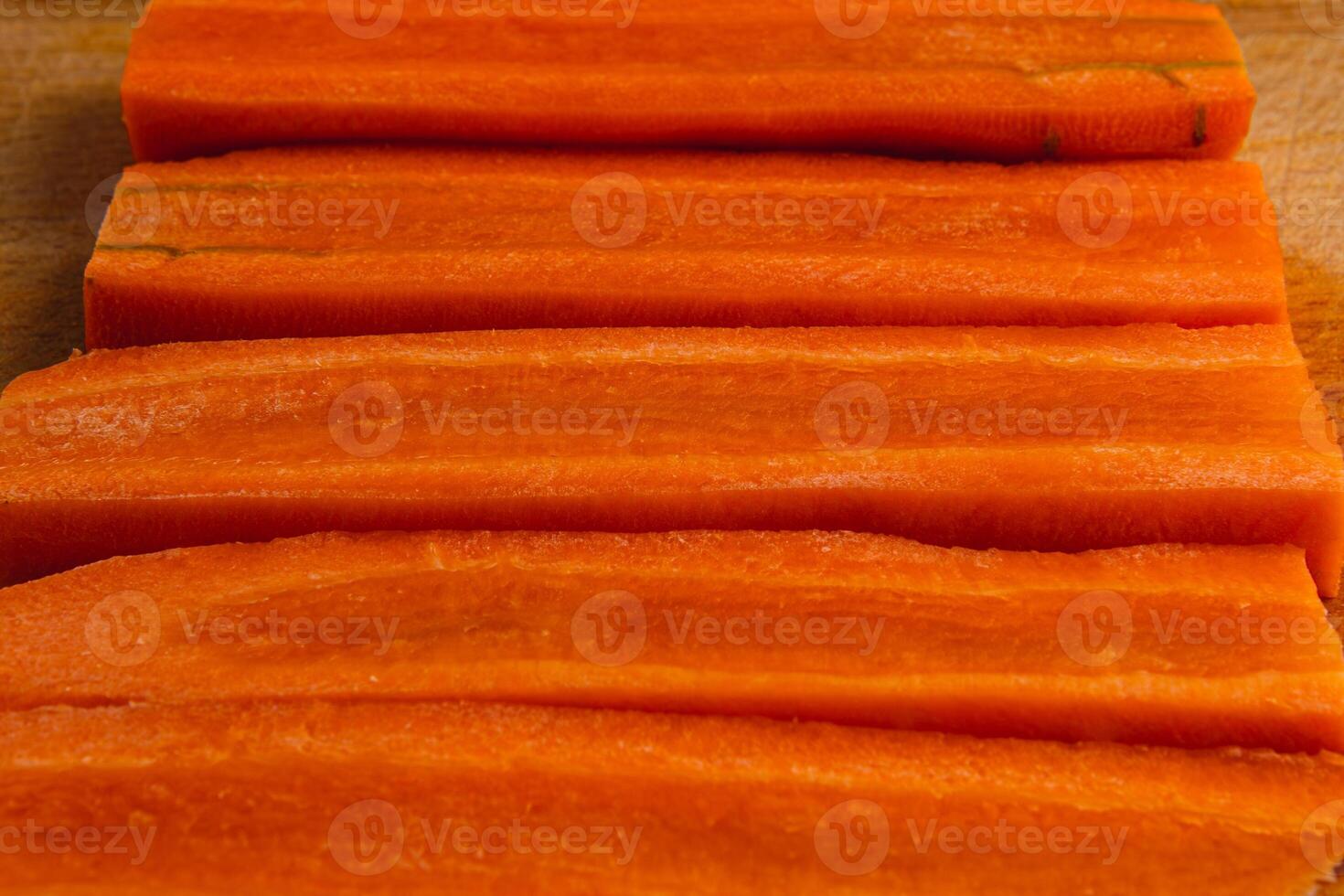 Cut carrots flat slice as background for healthy eating concept photo
