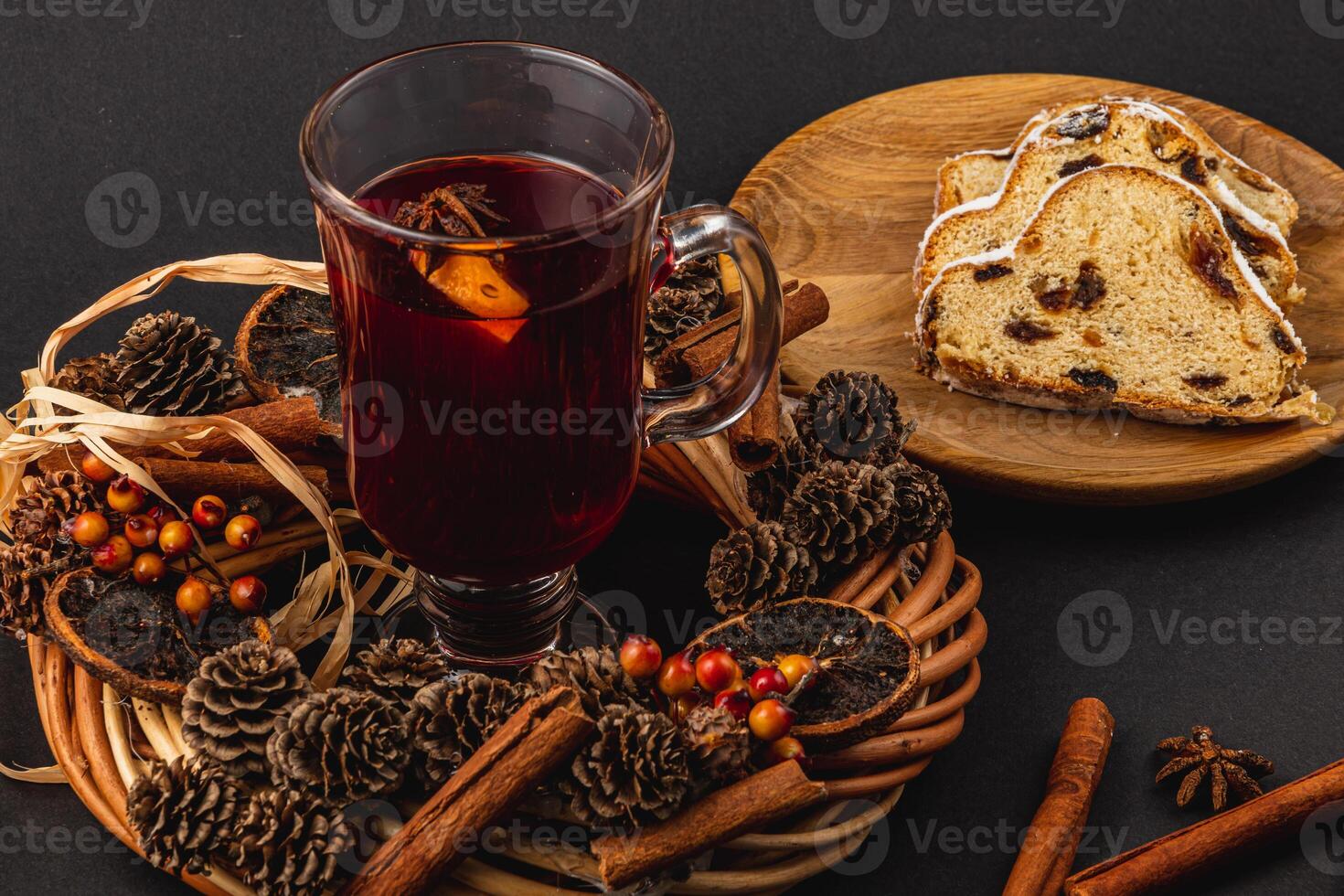 Festive Christmas mulled wine with stollen on a black background photo