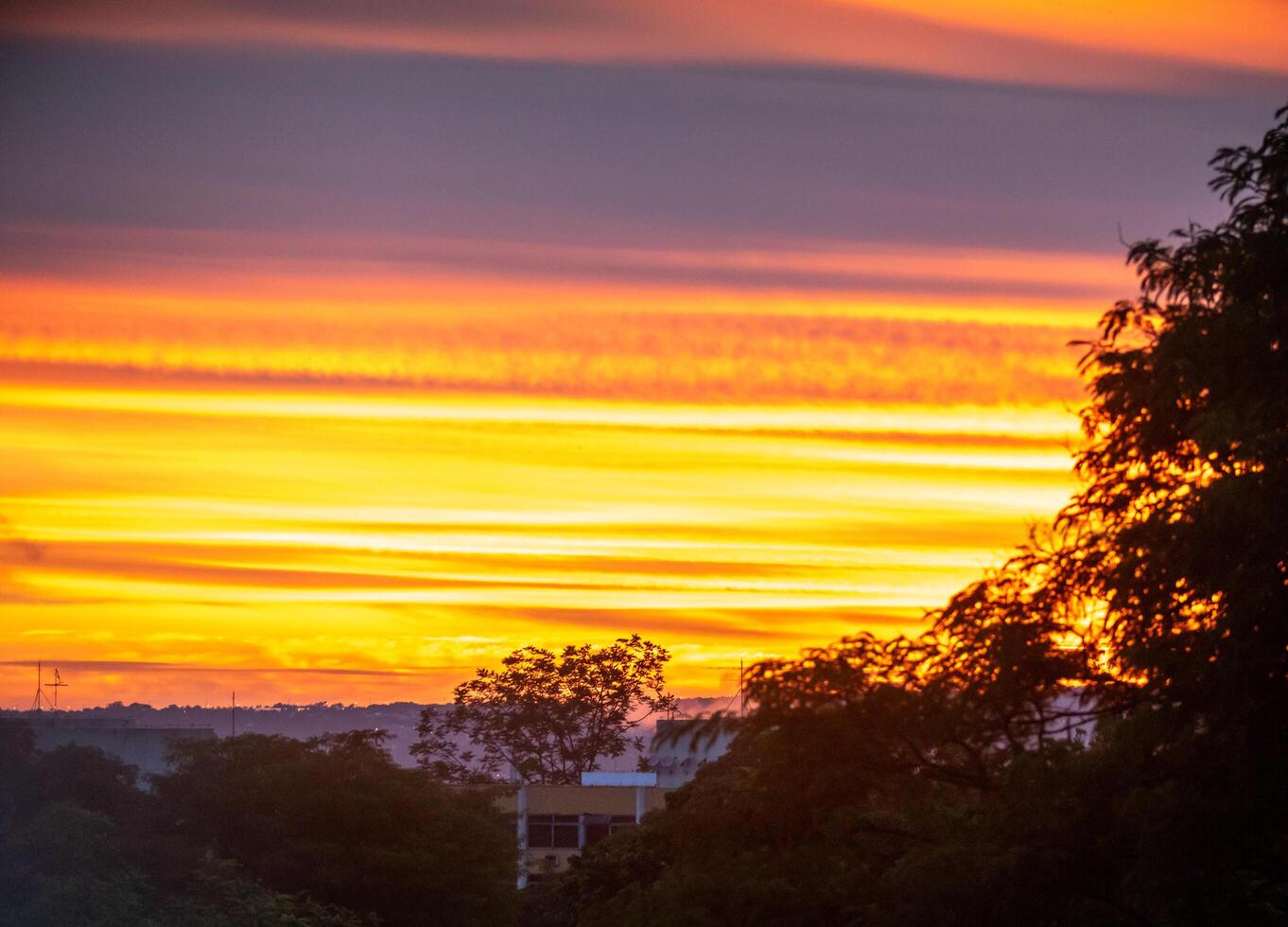 Sunrise with intense natural orange lights and idyllic dramatic scenery photo