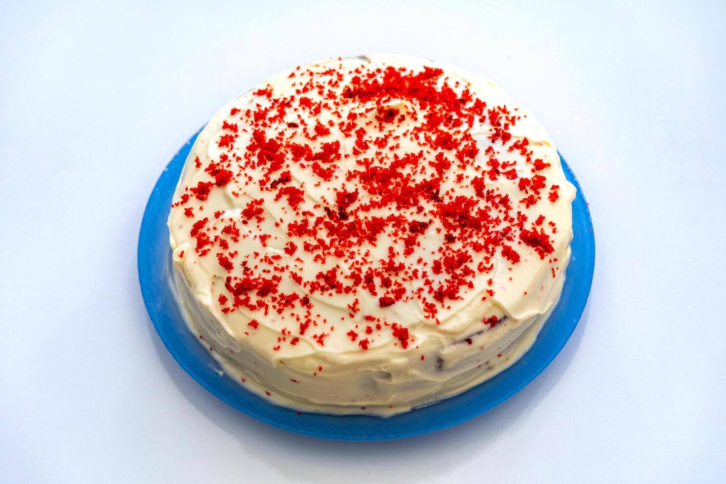 Traditional and delicious red velvet cake isolated on blue plate photo