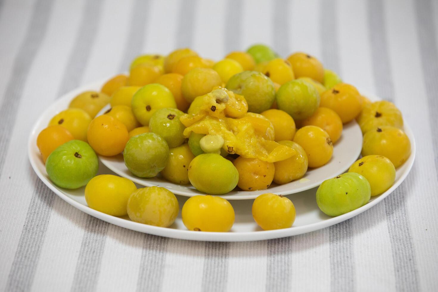 Ripe edible wild fruit from the Brazilian cerrado biome, fruit known as cagaita Stenocalyx dysentericus of the Magnoliopsida class and the Myrtaceae family. photo