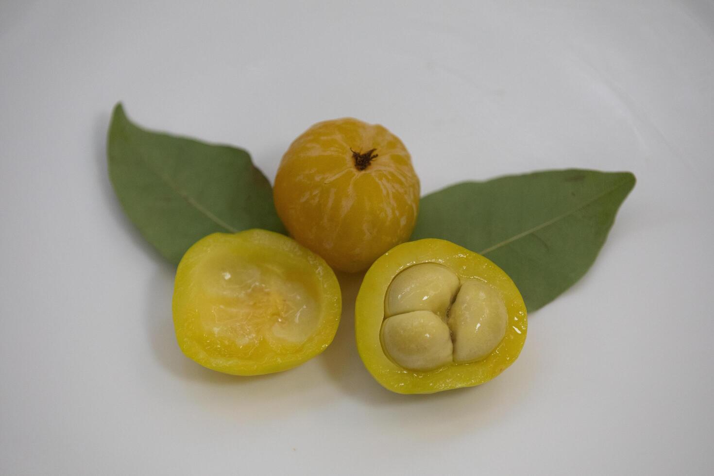 Ripe edible wild fruit from the Brazilian cerrado biome, fruit known as cagaita Stenocalyx dysentericus of the Magnoliopsida class and the Myrtaceae family. photo