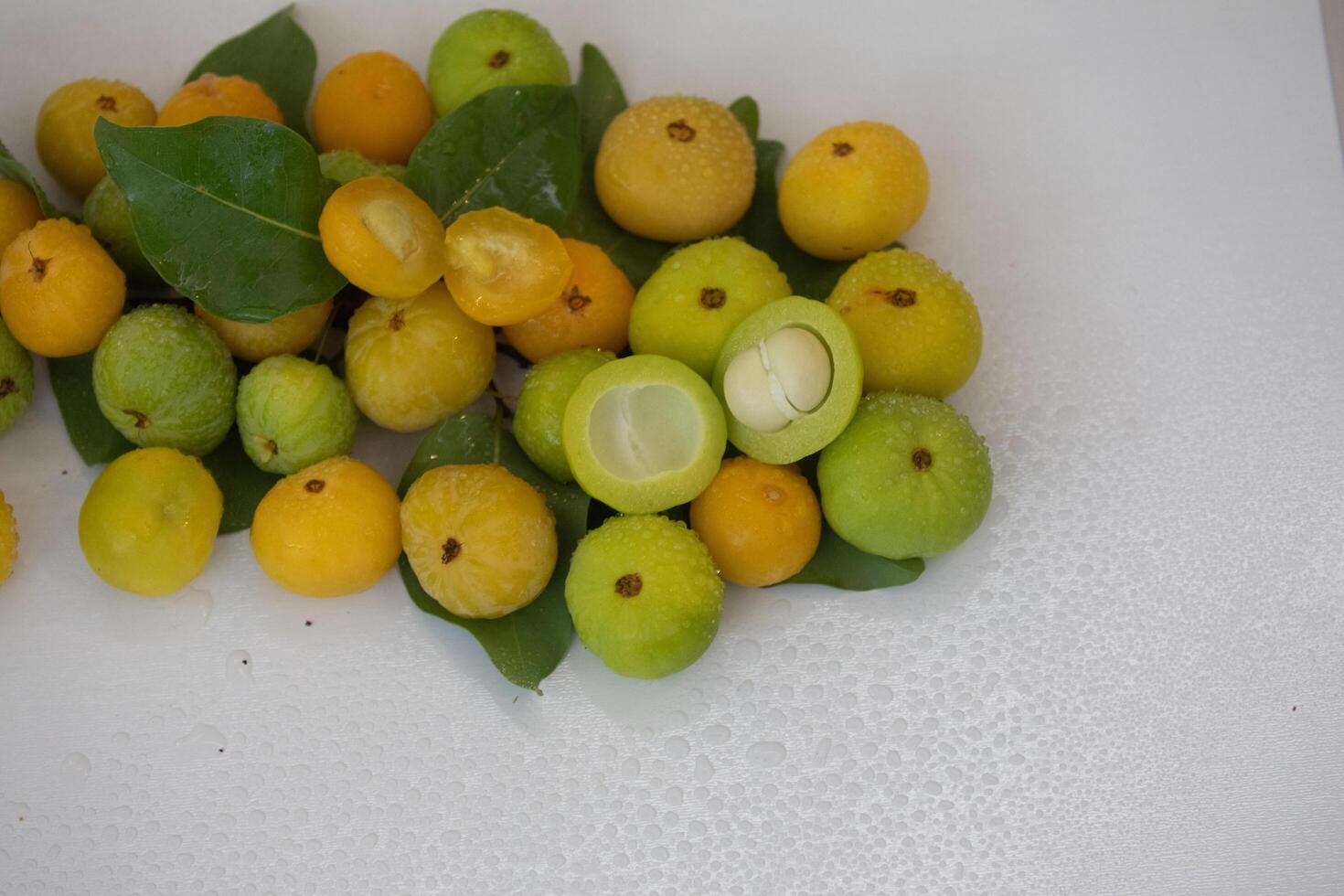 Ripe edible wild fruit from the Brazilian cerrado biome, fruit known as cagaita Stenocalyx dysentericus of the Magnoliopsida class and the Myrtaceae family. photo