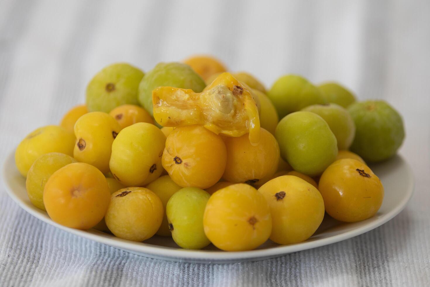 Ripe edible wild fruit from the Brazilian cerrado biome, fruit known as cagaita Stenocalyx dysentericus of the Magnoliopsida class and the Myrtaceae family. photo