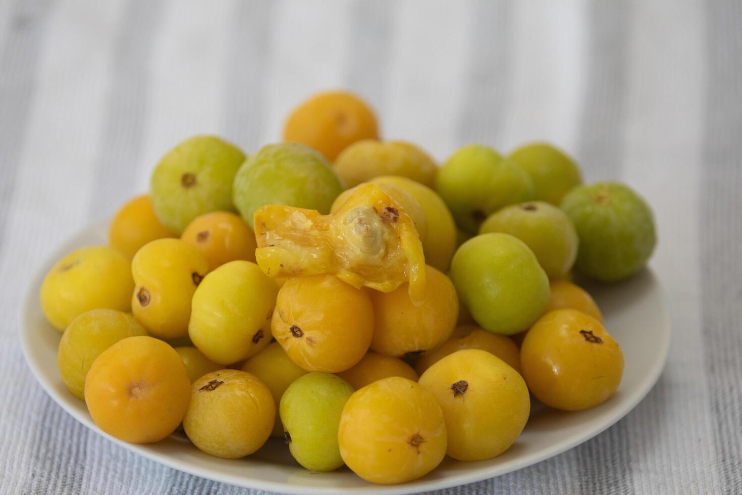 Ripe edible wild fruit from the Brazilian cerrado biome, fruit known as cagaita Stenocalyx dysentericus of the Magnoliopsida class and the Myrtaceae family. photo