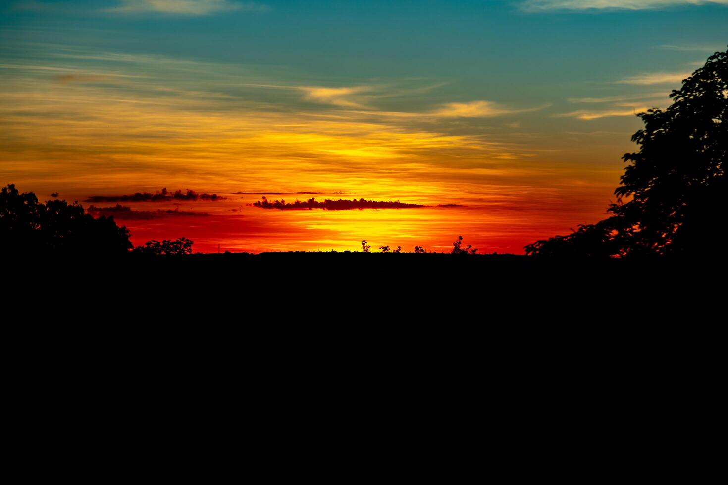 Sunrise with intense natural orange lights and idyllic dramatic scenery photo