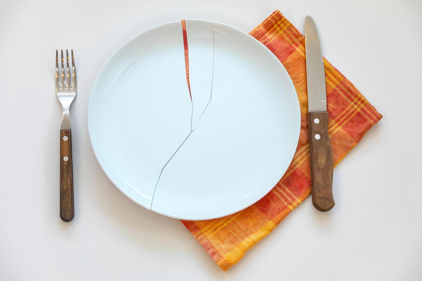 Empty plate top view with metal cutlery next to it photo