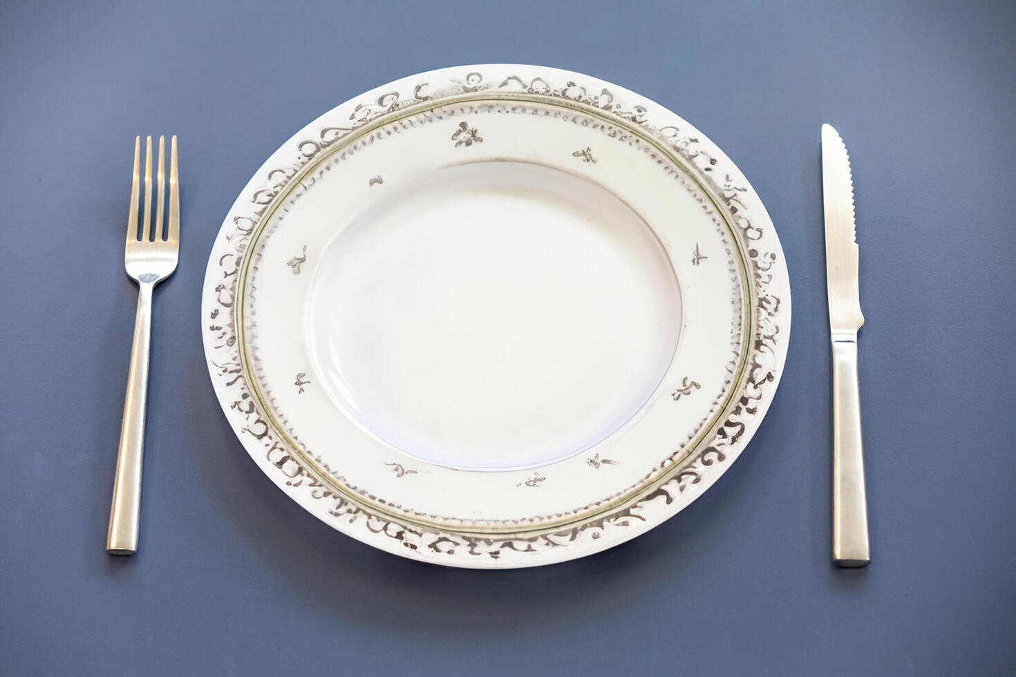 Empty plate top view with metal cutlery next to it photo