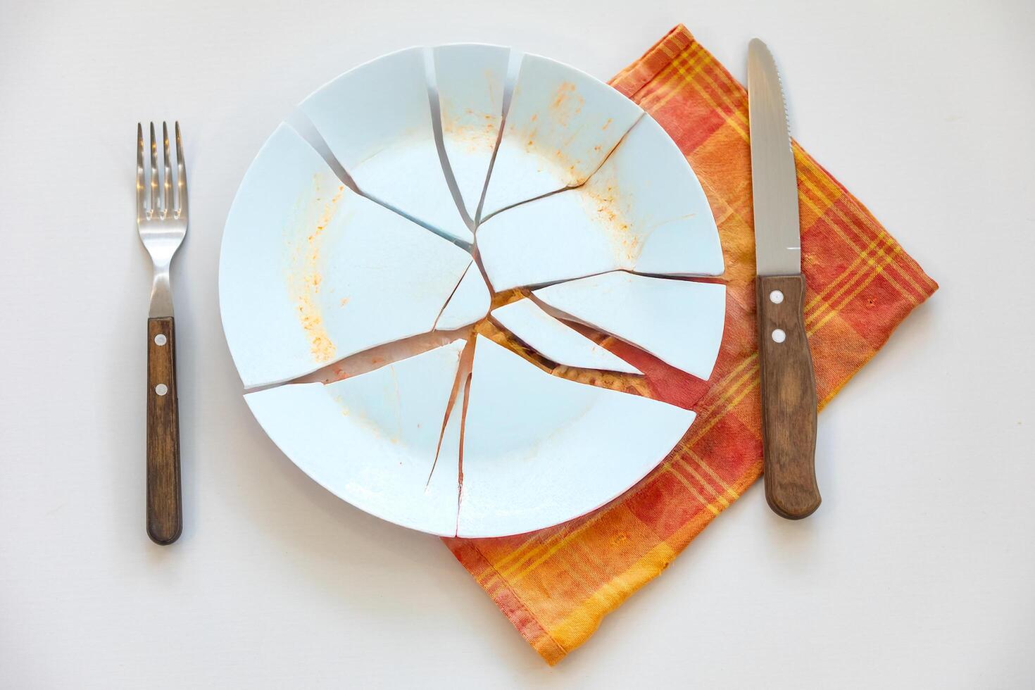 Empty plate top view with metal cutlery next to it photo