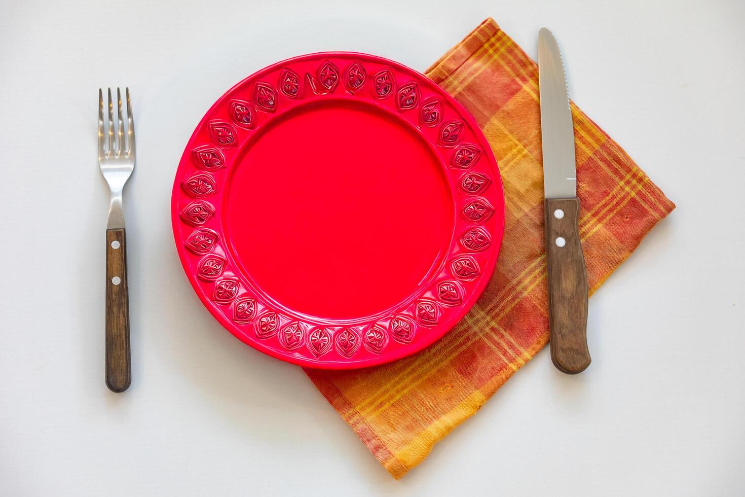 Empty plate top view with metal cutlery next to it photo